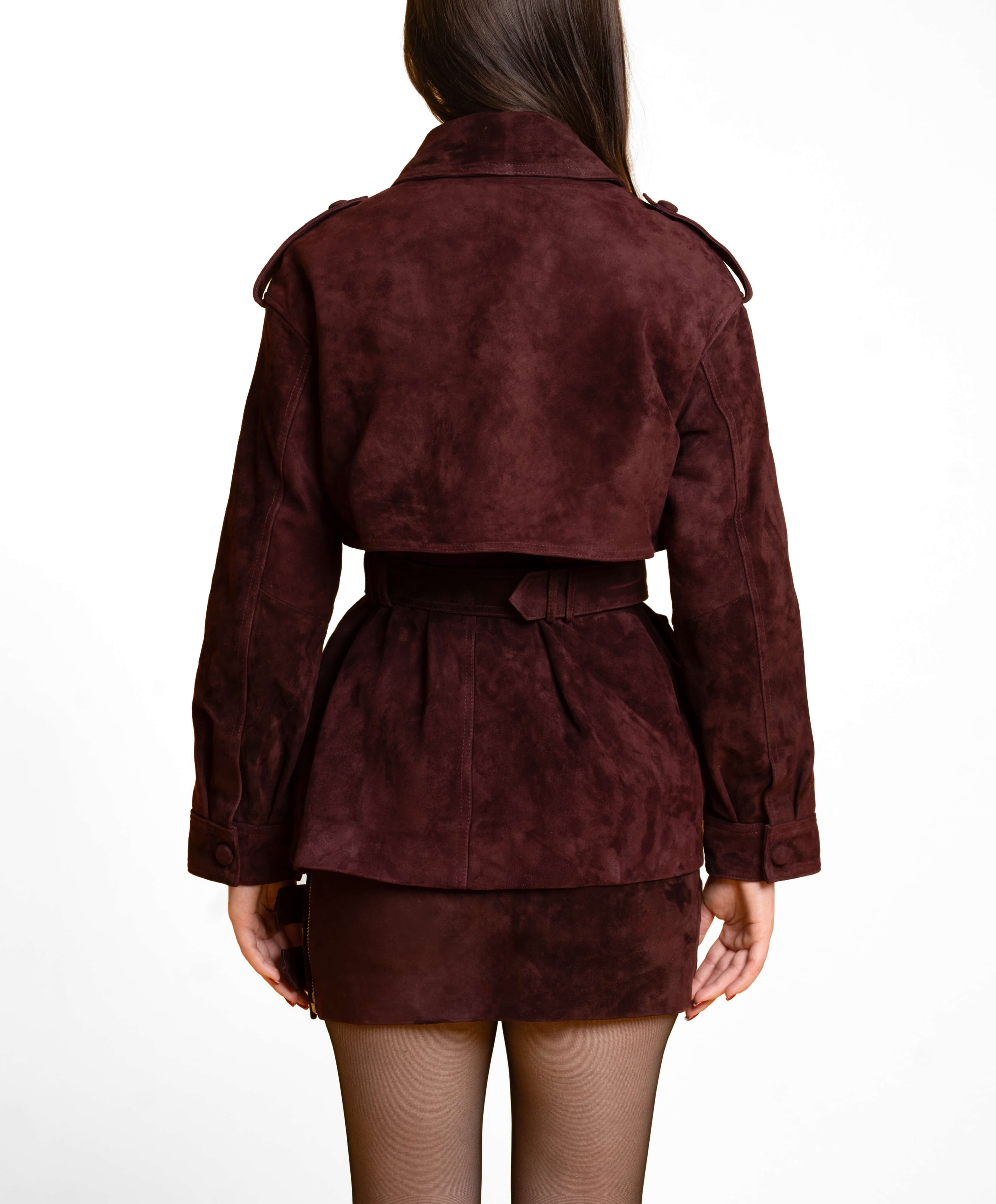 Close-up of hand-stitched suede coat seam detail showcasing artisan craftsmanship